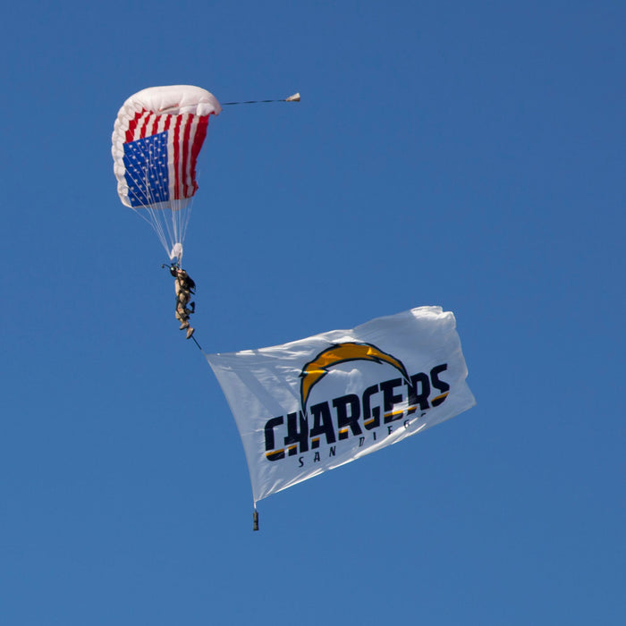 Image of Skydivers flying large corporate flags